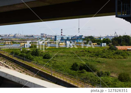 Urban Landscape that incorporates both Industrial Features and lush Greenery harmoniously Urban Landscape that incorporates both Industrial Features and lush Greenery harmoniously 127826351