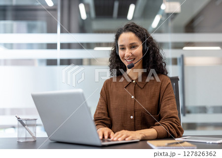 Support service worker working inside office with laptop and headset. Businesswoman using laptop for video call, online business meeting conference. 127826362