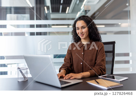 Successful woman working with laptop inside office. Businesswoman confident and satisfied at workplace, typing on keyboard preparing electronic presentation financial report. Successful woman working with laptop inside office. Businesswoman confident and satisfied at workplace, typing on keyboard preparing electronic presentation financial report. 127826468
