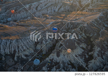 Balloons fly over Cappadocia at sunrise. Balloons fly over Cappadocia at sunrise. 127826595