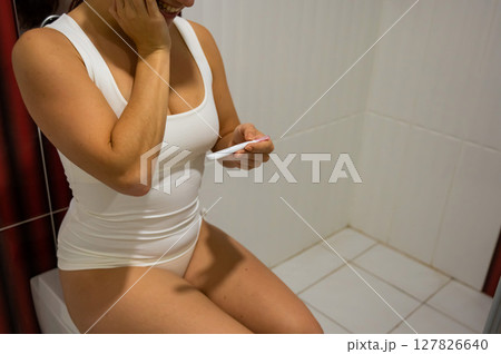 Woman upset by pregnancy test result.  127826640