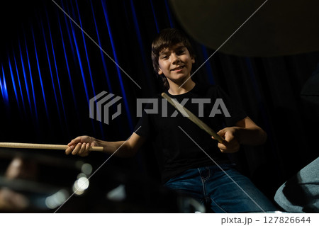 A boy plays drums in a recording studio A boy plays drums in a recording studio 127826644