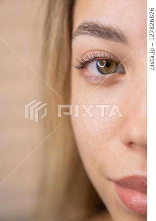 Close-up of a woman's eye after eyelash lamination procedure. Close-up of a woman's eye after eyelash lamination procedure. 127826876