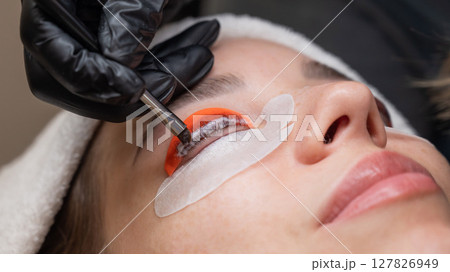 Caucasian woman undergoing eyelash lamination procedure.  127826949