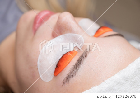 Caucasian woman undergoing eyelash lamination procedure.  127826979