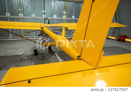 Yellow airplane glider in the hangar. Yellow airplane glider in the hangar. 127827007