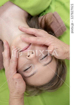 Top view of woman getting facial massage.  127827021