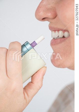 Caucasian woman smoking electronic cigarette. Tobacco heating system. Caucasian woman smoking electronic cigarette. Tobacco heating system. 127827043