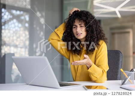 Upset and disappointed woman got error and laptop crash, unsatisfied woman looking at laptop screen. Office worker inside office at workplace. Upset and disappointed woman got error and laptop crash, unsatisfied woman looking at laptop screen. Office worker inside office at workplace. 127828024