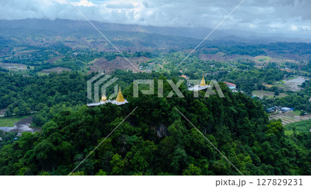 Rainy season landscape of mountain village in the morning and mountains in the background, Buddha statue, temple, mountains are visible as a viewpoint. Rainy season landscape of mountain village in the morning and mountains in the background, Buddha statue, temple, mountains are visible as a viewpoint. 127829231
