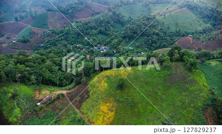 Rainy season landscape of a mountain village in the morning and mountains in the background. 127829237