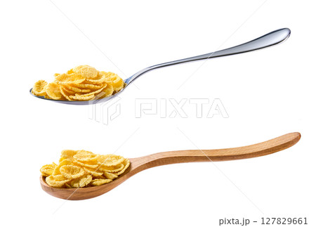 corn flakes in a metal spoon isolated on white background . 127829661