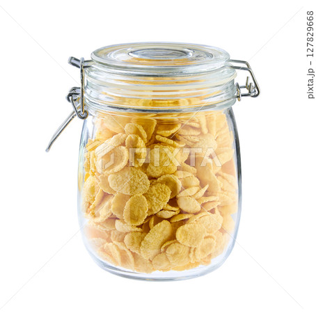 glass jar with cornflakes isolated on a white background. glass jar with cornflakes isolated on a white background. 127829668