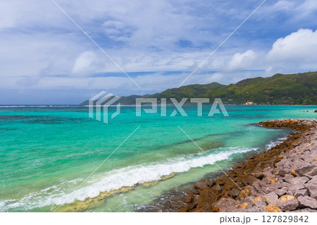 Mahe island, Seychelles. Clear turquoise waters meet the lush green coastline Mahe island, Seychelles. Clear turquoise waters meet the lush green coastline 127829842