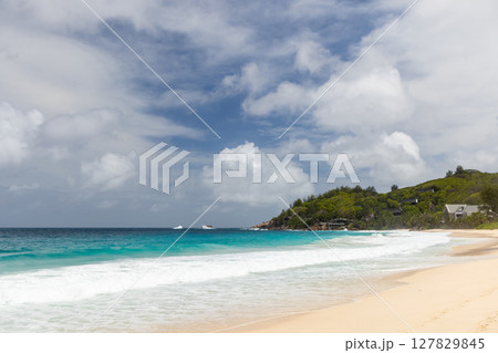Mahe island, Seychelles. Tranquil tropical beach featuring crystal clear waters Mahe island, Seychelles. Tranquil tropical beach featuring crystal clear waters 127829845