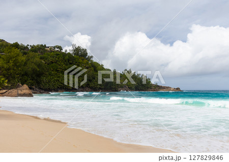 Mahe island, Seychelles. Tropical beach scene showcasing golden sand Mahe island, Seychelles. Tropical beach scene showcasing golden sand 127829846