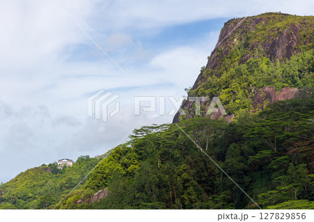 Mahe island, Seychelles. A picturesque landscape featuring a forested hill Mahe island, Seychelles. A picturesque landscape featuring a forested hill 127829856