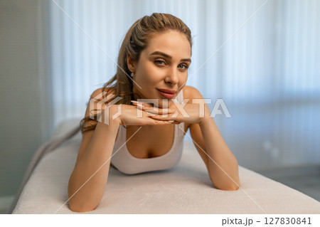 Woman getting treatment on buttocks to burn fat, build muscles and remove cellulite. Professional beauty salon 127830841