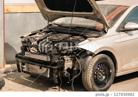 The car with the front hood open is waiting for repair The car with the front hood open is waiting for repair 127830982