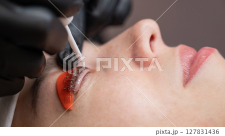 Caucasian woman undergoing eyelash lamination procedure.  127831436