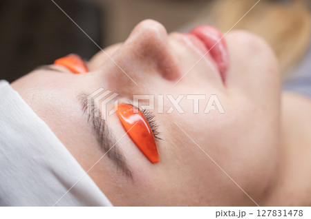 Caucasian woman undergoing eyelash lamination procedure. Caucasian woman undergoing eyelash lamination procedure. 127831478