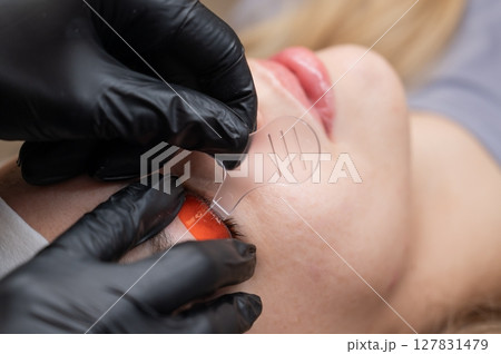 Caucasian woman undergoing eyelash lamination procedure. Caucasian woman undergoing eyelash lamination procedure. 127831479