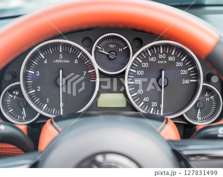 Close-Up View of a Sports Car Dashboard Displaying Gauges.  127831499