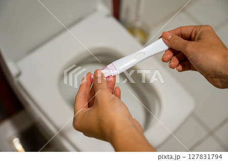 A woman takes an express pregnancy test. 127831794