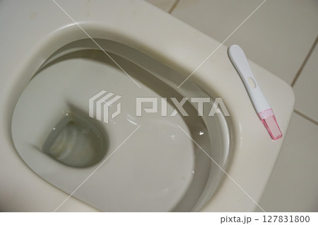 Pregnancy test on the toilet.  127831800