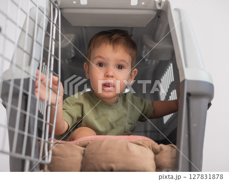 A small child in a closed cage. A small child in a closed cage. 127831878