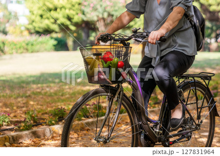 A Woman ride with bicycle to home from shopping A Woman ride with bicycle to home from shopping 127831964