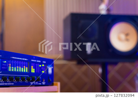 LED VU meter, audio meterbridge on loudspeaker monitor background in recording studio. music production, recording concept LED VU meter, audio meterbridge on loudspeaker monitor background in recording studio. music production, recording concept 127832094