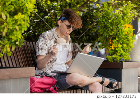 Sad man tourist working using laptop loses lottery casino game results bad news fortune loss fail 127833175