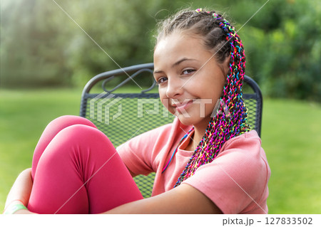 Portrait of cute little long haired girl. sitting outside. Portrait of cute little long haired girl. sitting outside. 127833502