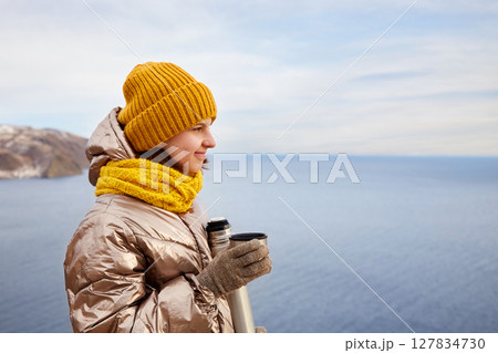 A young beautiful girl on a journey admires the beauty of nature. A young beautiful girl on a journey admires the beauty of nature. 127834730