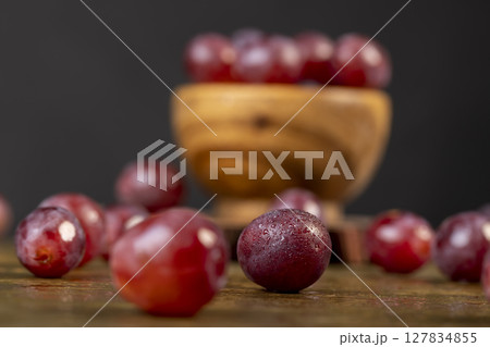 pink ripe grapes on the table after washing the berries 127834855