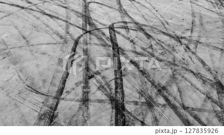 Aerial view car tire marks abstract street road background with black tire marks on race track, Texture and background car automobile and automotive skid tire marks. Aerial view car tire marks abstract street road background with black tire marks on race track, Texture and background car automobile and automotive skid tire marks. 127835926