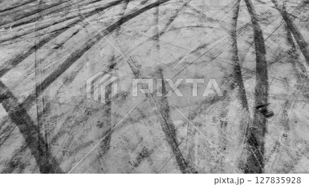 Aerial view car tire marks abstract street road background with black tire marks on race track, Texture and background car automobile and automotive skid tire marks. 127835928