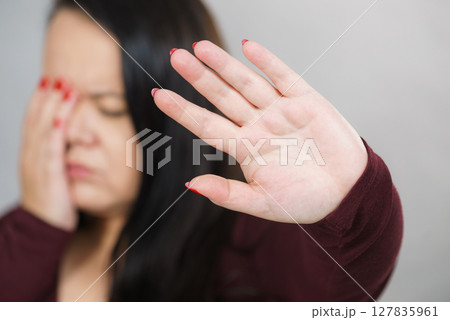 Scared woman with stop hand gesture Scared woman with stop hand gesture 127835961