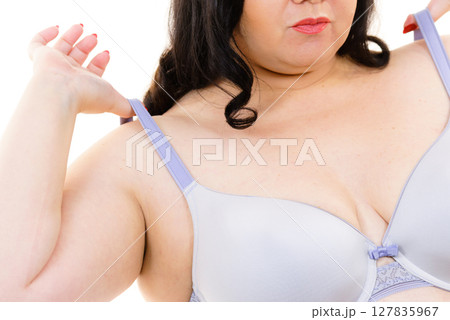 Big woman wearing lingerie holds bra strap Big woman wearing lingerie holds bra strap 127835967