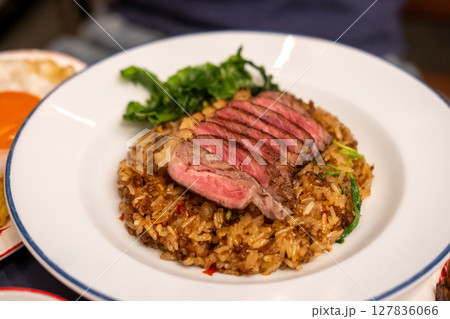 Stir-fried Basil with Rare beef steak served on plate. It is a popular Thai dish known as Pad Kra Pao Stir-fried Basil with Rare beef steak served on plate. It is a popular Thai dish known as Pad Kra Pao 127836066