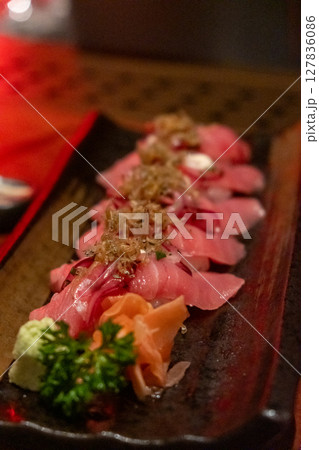 Tuna sushi with acebichado sauce, crispy shirou and salsa criolla. served on plate Tuna sushi with acebichado sauce, crispy shirou and salsa criolla. served on plate 127836086