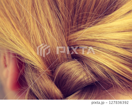 Closeup of woman blonde braided hair 127836392