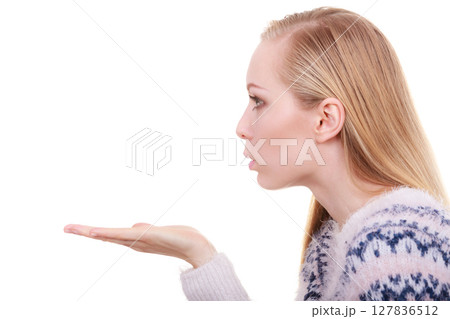 Blonde womn sending air kiss on palm hand Blonde womn sending air kiss on palm hand 127836512