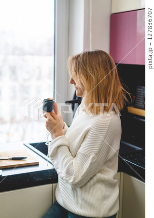 woman enjoying morning coffee woman enjoying morning coffee 127836707