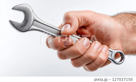 Hand gripping a metal wrench tool against a bright white background Hand gripping a metal wrench tool against a bright white background 127837150