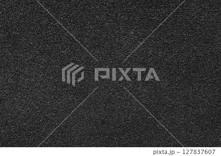 Grainy texture of black colored asphalt, plaster, cement, plastic close up, macro background 127837607