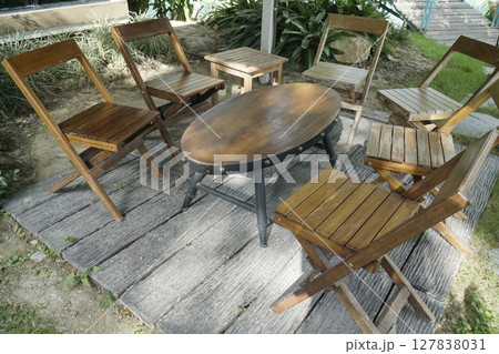 Wooden patio set with a round table and four chairs 127838031