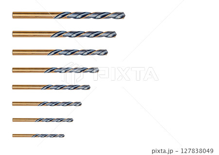 Set of eight pieces of bronze metal drill bits, gold-colored spiral cutting side edges, dark grooves isolated on white background with clipped path. Construction Tool Consumables. Drilling equipment Set of eight pieces of bronze metal drill bits, gold-colored spiral cutting side edges, dark grooves isolated on white background with clipped path. Construction Tool Consumables. Drilling equipment 127838049