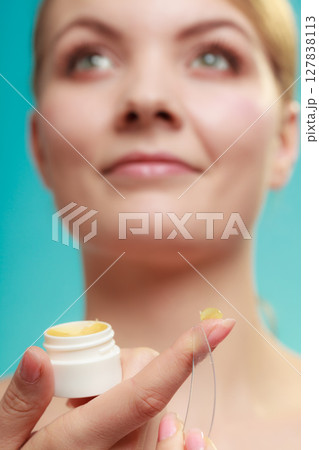 woman applying balsam for lips woman applying balsam for lips 127838113